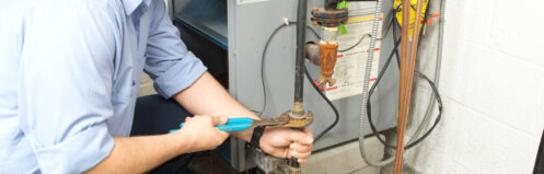 Repairman repairing furnace
