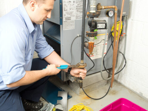 Repairman repairing furnace