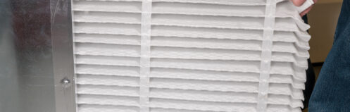 A man changing the HVAC air filter